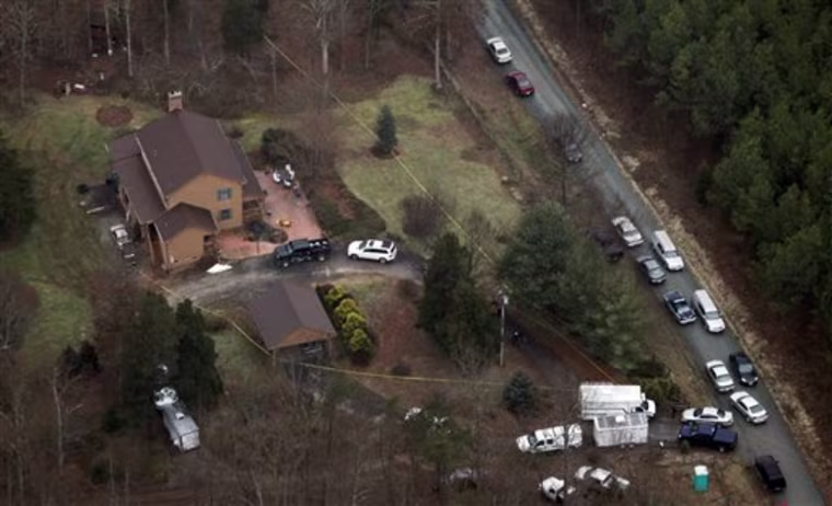 Two hearses arrive to pick up victims at a home where eight people were shot in Appomattox, Va., Wednesday, Jan. 20, 2010. Officers captured Christopher Speight, who is accused of killing eight people and leading police on an overnight manhunt.  (AP Photo/Steve Helber)
